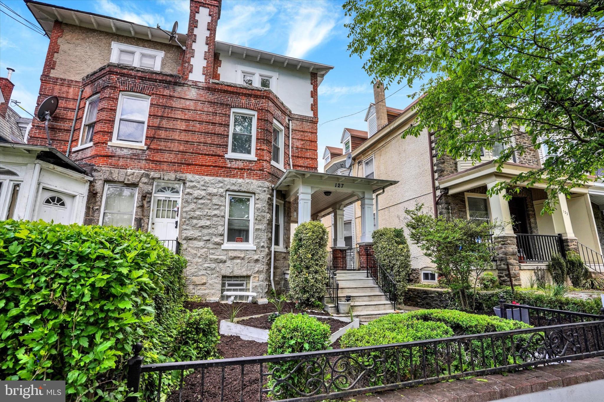 127 West Washington Lane Philadelphia, PA 19144 - Photo 2 of 29 Charming brick facade with lush greenery.