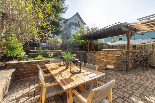a view of a patio with table and chairs and potted plants