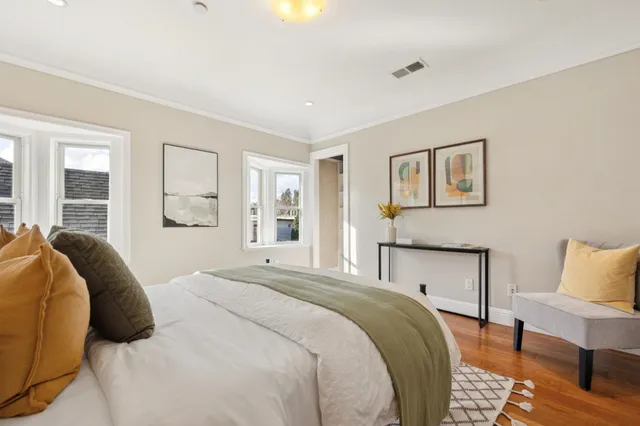 a bedroom with a large bed and a couch