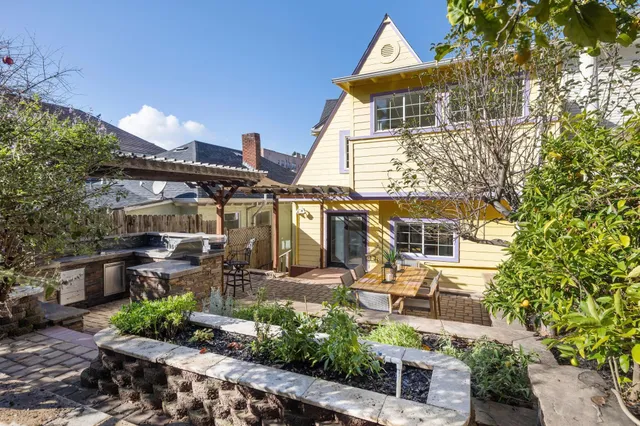 a front view of a house with a garden