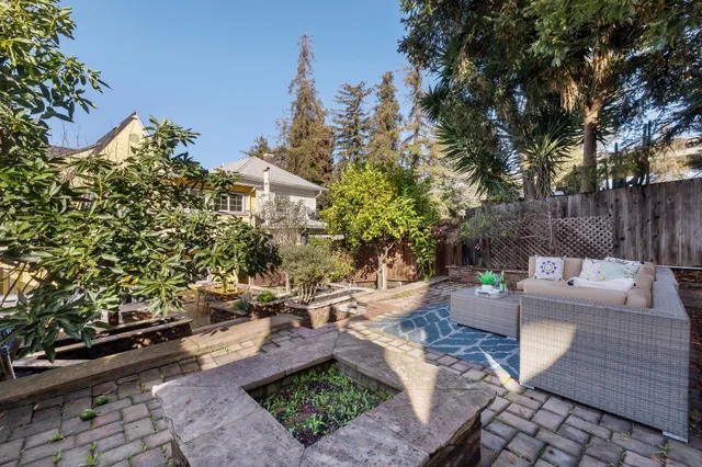 a view of a backyard with sitting area