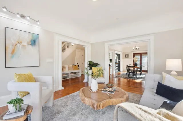 a living room with furniture and wooden floor