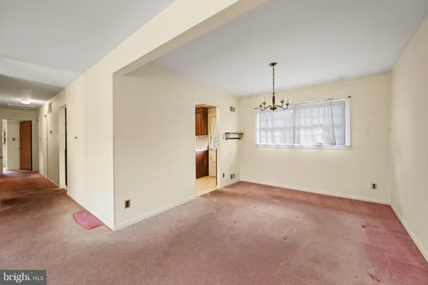 an empty room with windows and cabinet