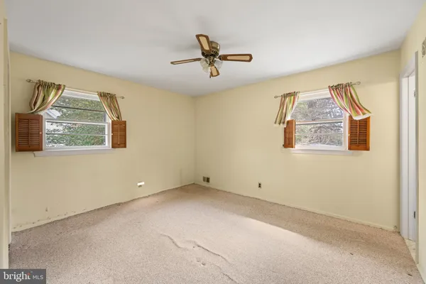 a view of a livingroom with a ceiling fan and a window