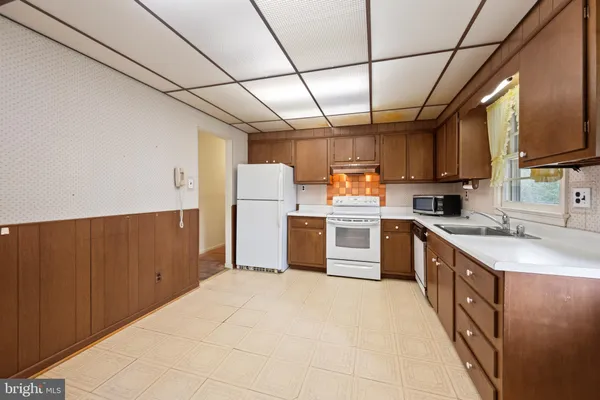 a kitchen with sink cabinets and window