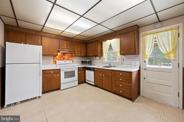 a kitchen that has a sink and a stove