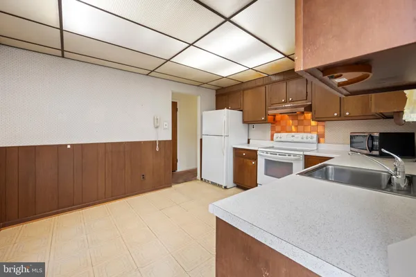 a view of a room with wooden cabinets