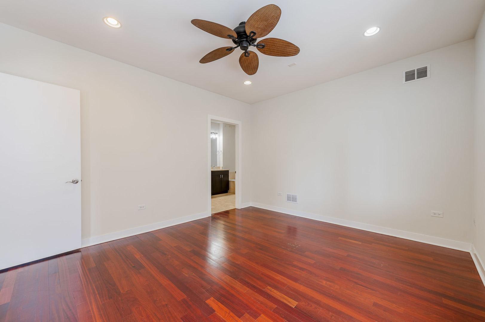 1162 West Hubbard Street, Unit 203 Chicago, IL 60642 - Photo 11 of 22 an empty room with wooden floor and a ceiling fan
