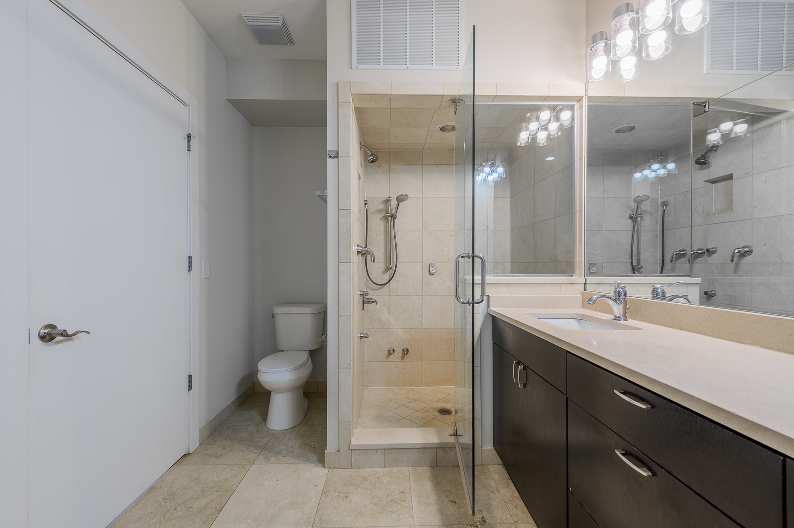 1162 West Hubbard Street, Unit 203 Chicago, IL 60642 - Photo 13 of 22 a spacious bathroom with a double vanity sink toilet and shower