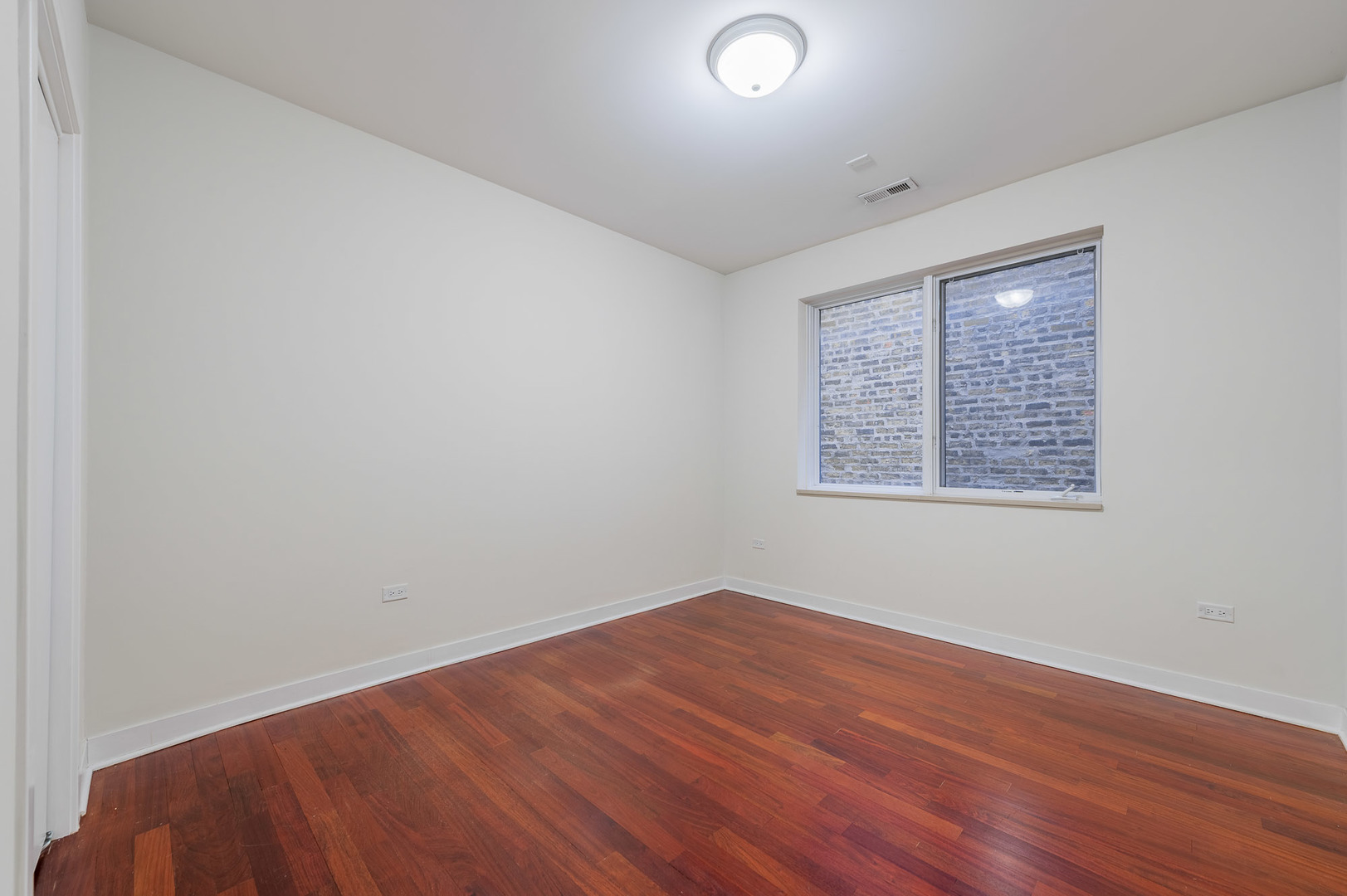 1162 West Hubbard Street, Unit 203 Chicago, IL 60642 - Photo 17 of 22 an empty room with wooden floor and windows