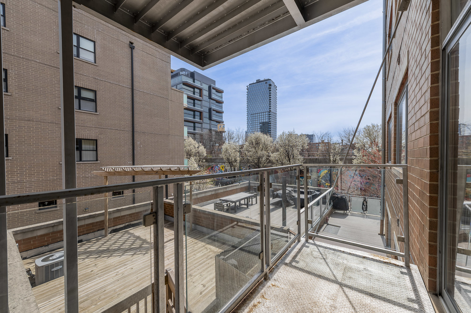 1162 West Hubbard Street, Unit 203 Chicago, IL 60642 - Photo 20 of 22 a view of balcony with two chairs and a rug