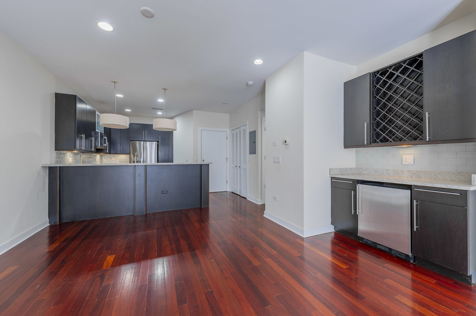 1162 West Hubbard Street, Unit 203 Chicago, IL 60642 - Photo 2 of 22 a view of kitchen with cabinets and wooden floor