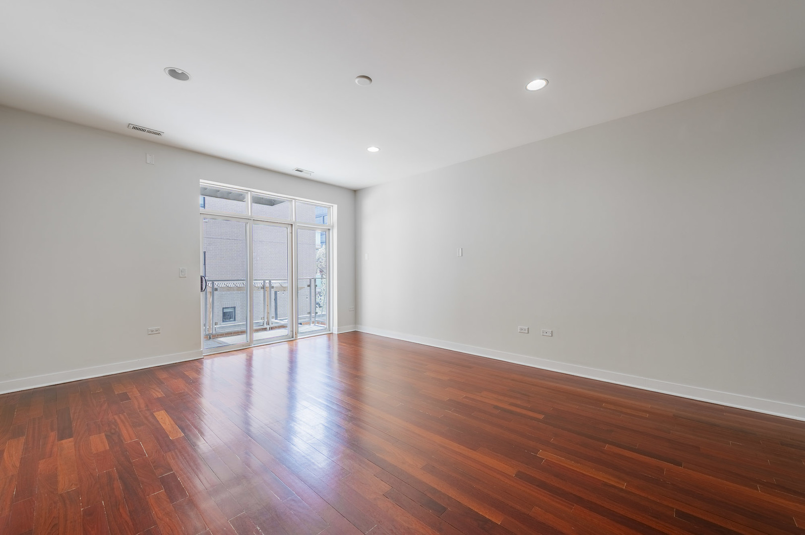 1162 West Hubbard Street, Unit 203 Chicago, IL 60642 - Photo 8 of 22 a view of an empty room with wooden floor and a window