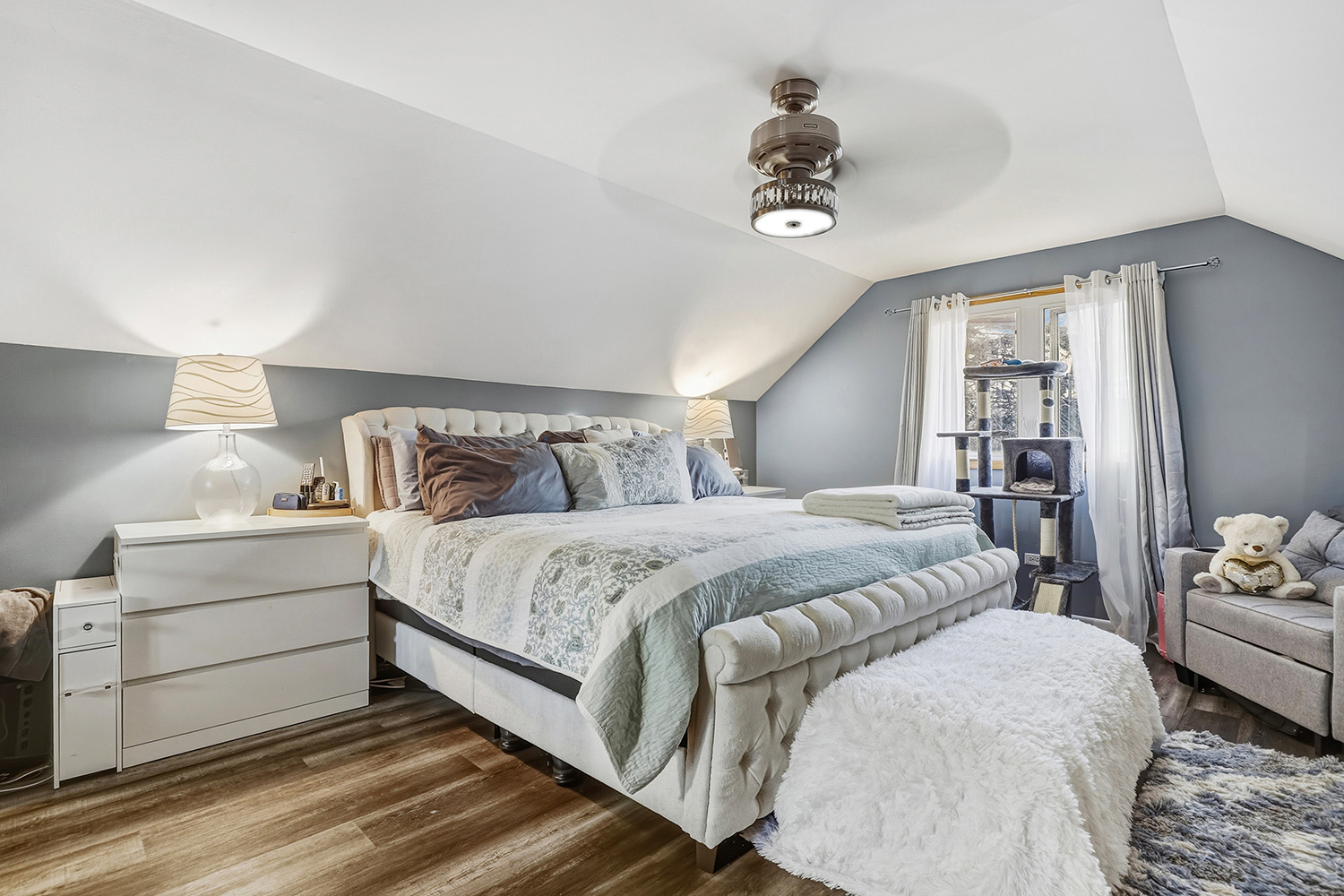 11S450 Carpenter Street Lemont, IL 60439 - Photo 12 of 29 a bedroom with a large bed and a chandelier