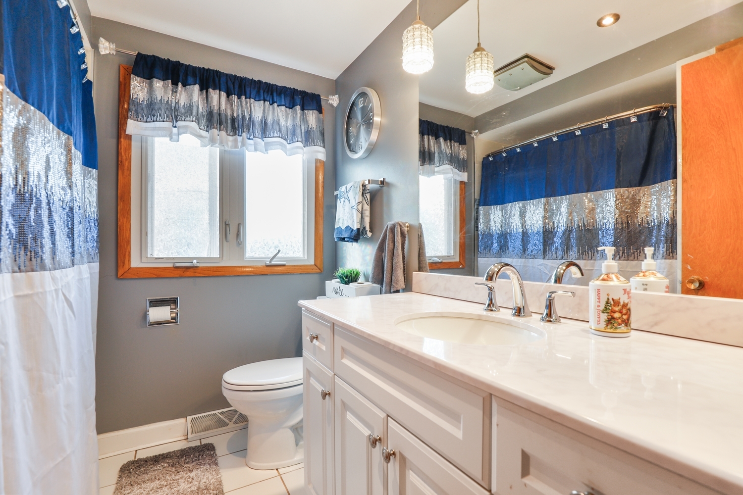 11S450 Carpenter Street Lemont, IL 60439 - Photo 13 of 29 a bathroom with a sink a toilet and a mirror