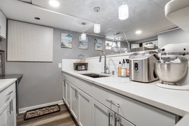 a kitchen with a sink and a stove top oven