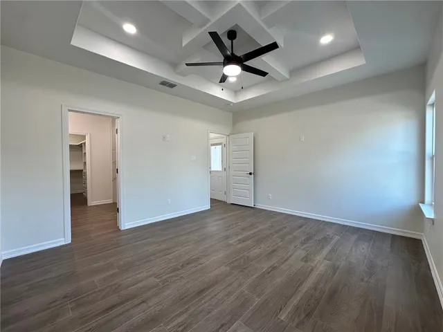 a view of an empty room and wooden floor