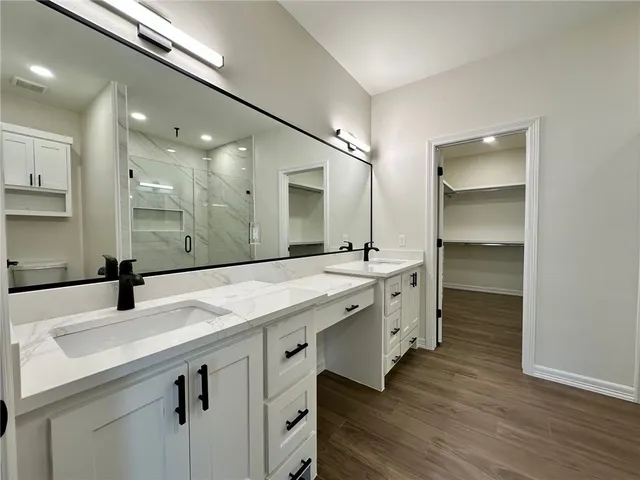 a bathroom with a sink double vanity and a mirror