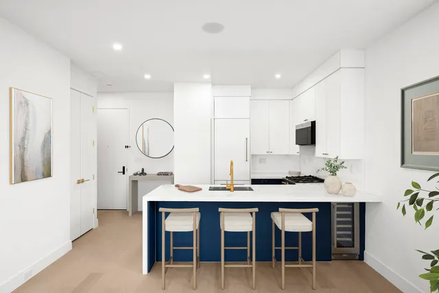 a view of a dining room with furniture and a potted plant