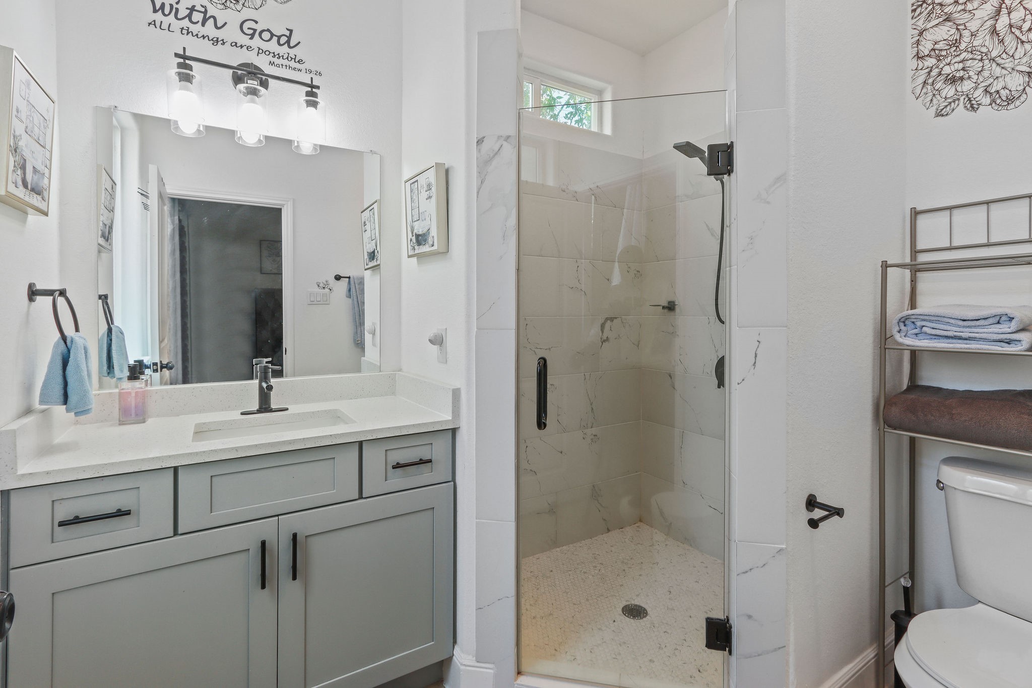 5607 Bacher Street, Unit B Houston, TX 77028 - Photo 9 of 20 a bathroom with a shower sink vanity and mirror