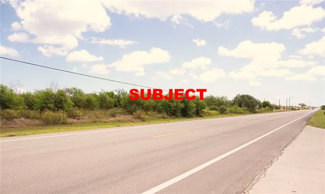 a street sign on a wall next to a road