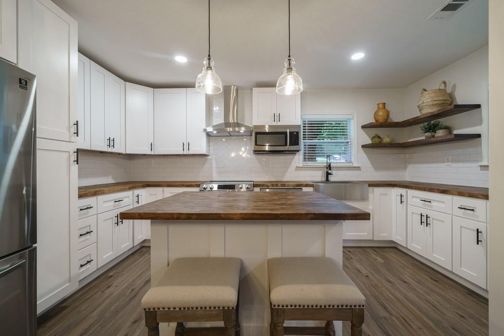 2359 Mark Trail Decatur, GA 30032 - Photo 5 of 35 a kitchen with stainless steel appliances granite countertop a sink a stove and chairs
