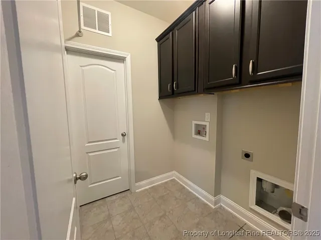 a view of a storage and utility room with wooden floor