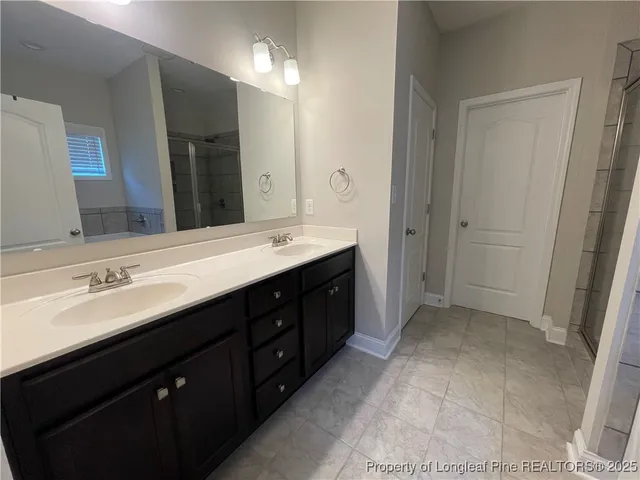 a spacious bathroom with a double vanity sink mirror and double