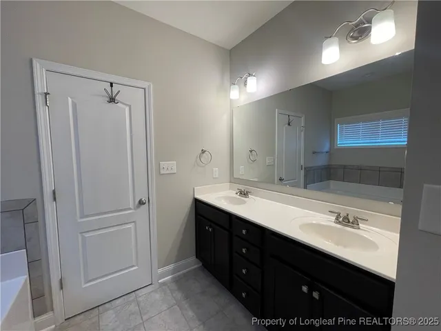 a bathroom with a double vanity sink a and mirror