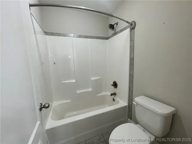 a bathroom with a toilet and a bathtub