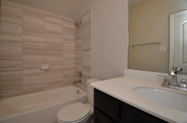 a bathroom with a sink a toilet and bathtub