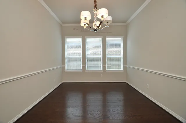 a view of wooden floor and a chandelier in a room