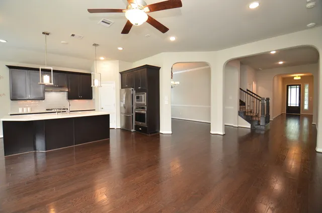 a view of kitchen with sink and refrigerator