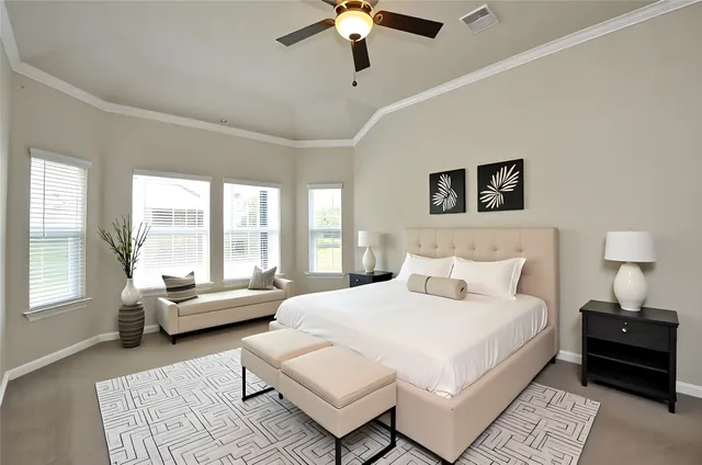 a bedroom with a bed couches and a chandelier