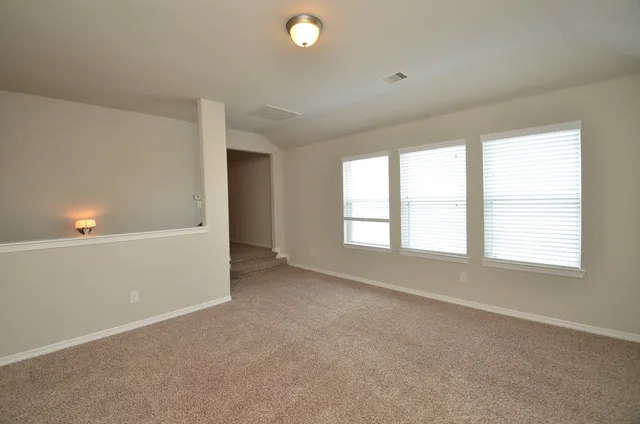 an empty room with windows and closet