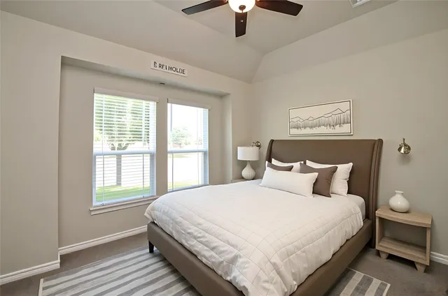 a bedroom with a large bed and a window