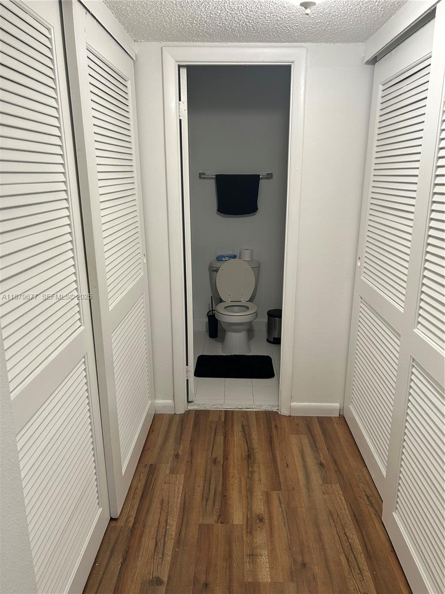 17901 Northwest 68th Avenue, Unit R209 Hialeah, FL 33015 - Photo 12 of 40 a hallway with wooden floor