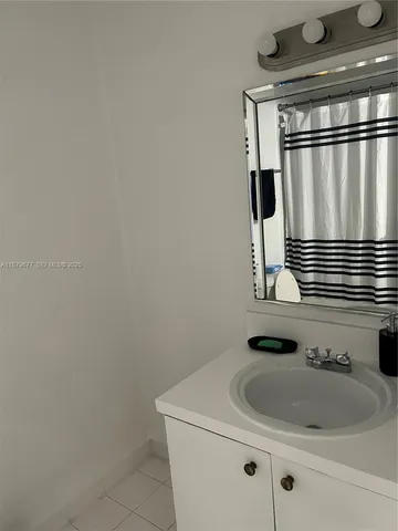 a bathroom with a sink and mirror