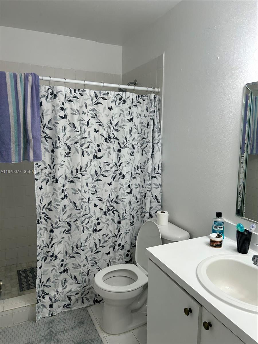 17901 Northwest 68th Avenue, Unit R209 Hialeah, FL 33015 - Photo 16 of 40 a bathroom with a sink and a toilet