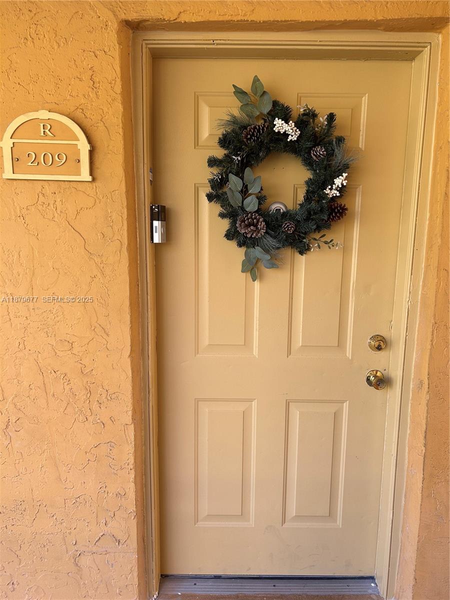 17901 Northwest 68th Avenue, Unit R209 Hialeah, FL 33015 - Photo 18 of 40 a bathroom with a sink and a mirror