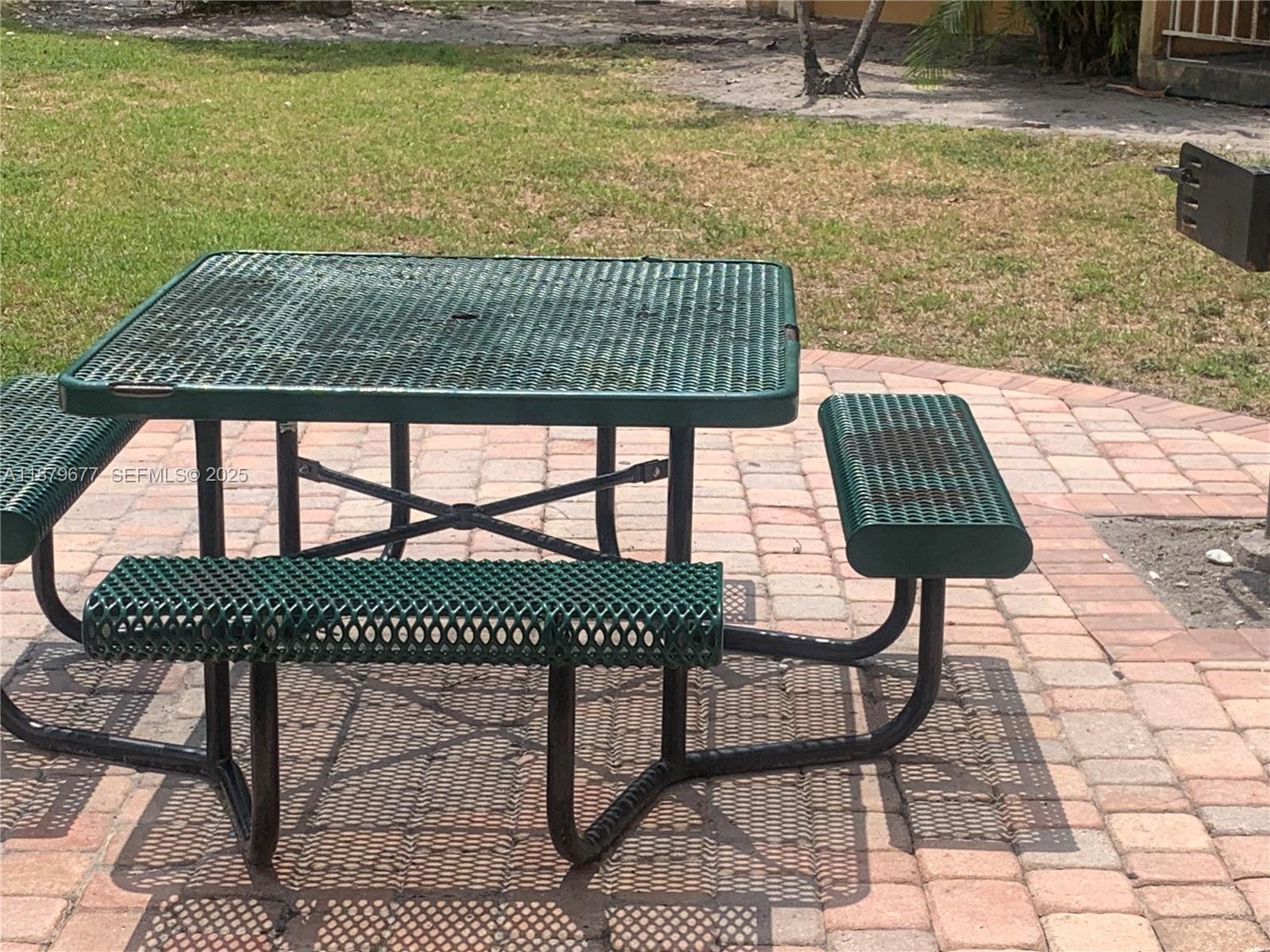 17901 Northwest 68th Avenue, Unit R209 Hialeah, FL 33015 - Photo 33 of 40 a view of a roof deck with table and chairs and wooden floor