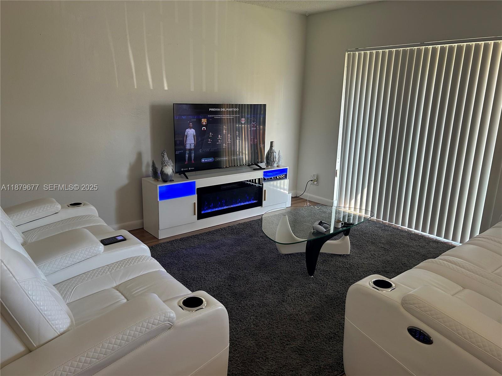 17901 Northwest 68th Avenue, Unit R209 Hialeah, FL 33015 - Photo 6 of 40 a living room with furniture and a couch