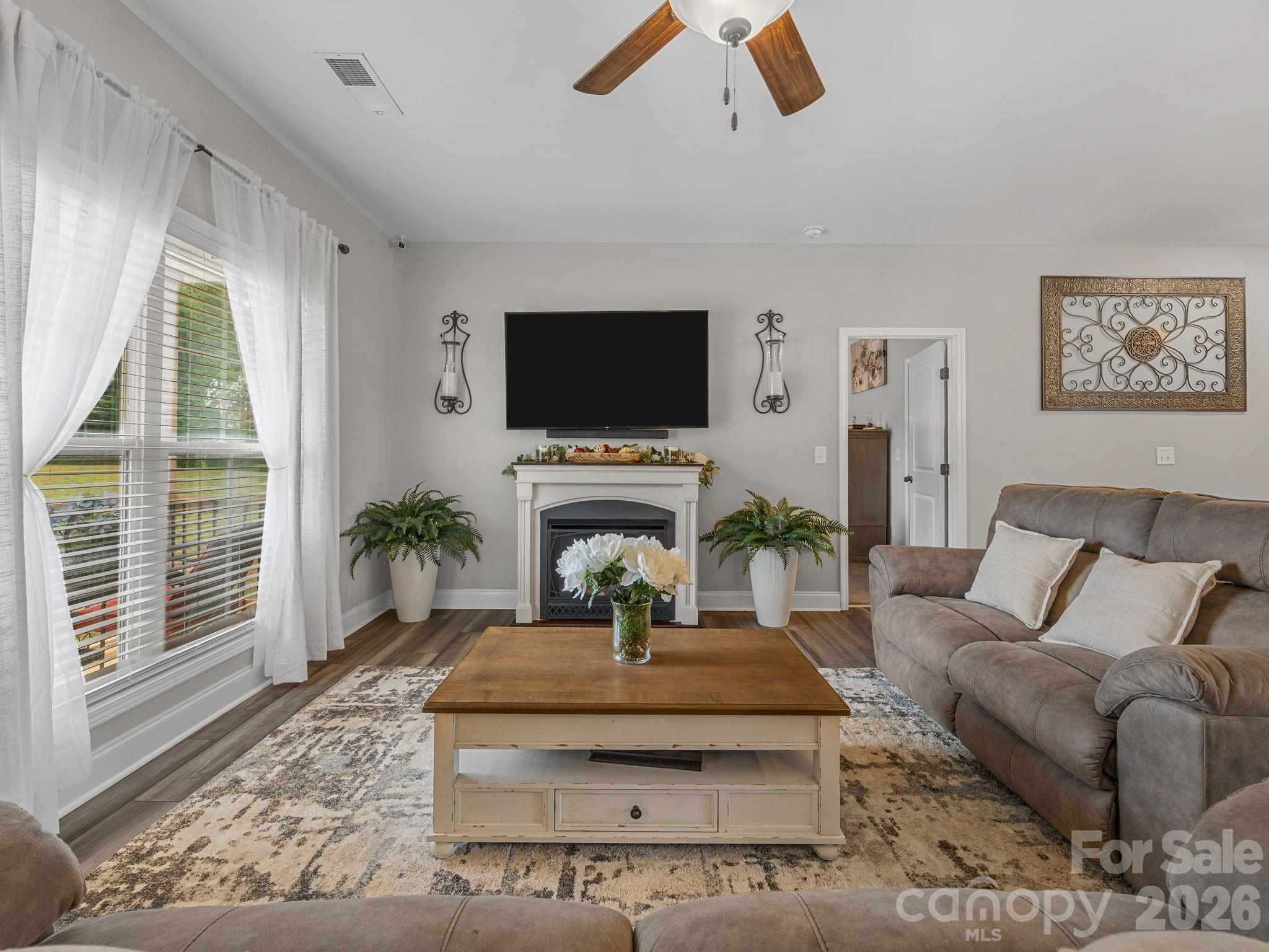 1076 McSwain Road Chesnee, SC 29323 - Photo 5 of 36 a living room with furniture a flat screen tv and a fireplace