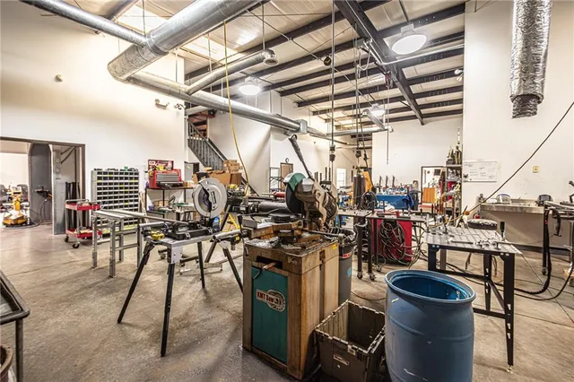 a view of a house with a big yard potted plants and large tree