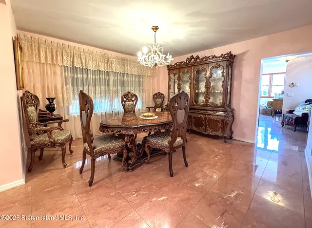 a view of a dining room with furniture and chandelier