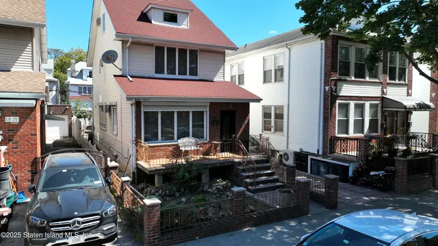 an aerial view of multiple houses with a yard