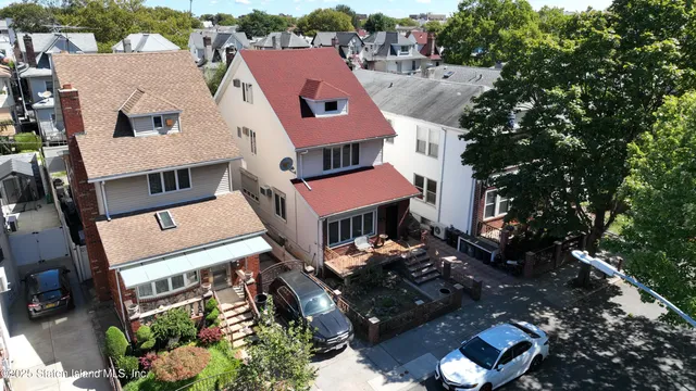 an aerial view of multiple houses with yard