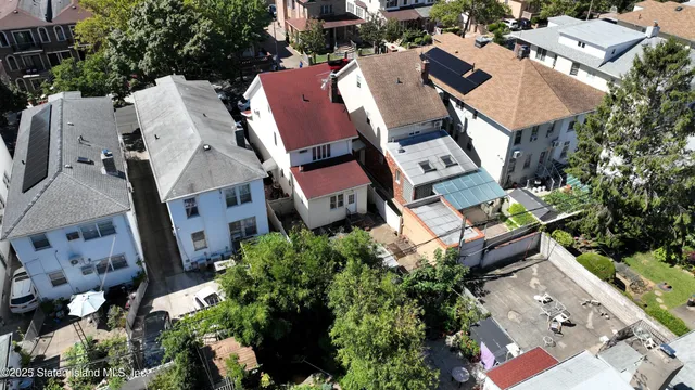 an aerial view of a house with outdoor space and street view