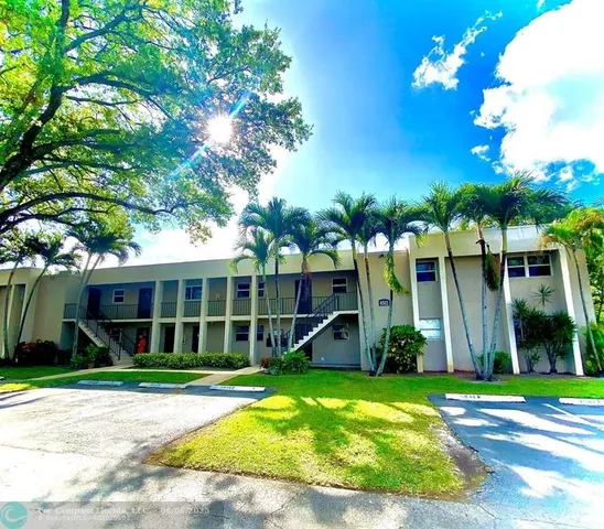 a view of a house with a yard and plants