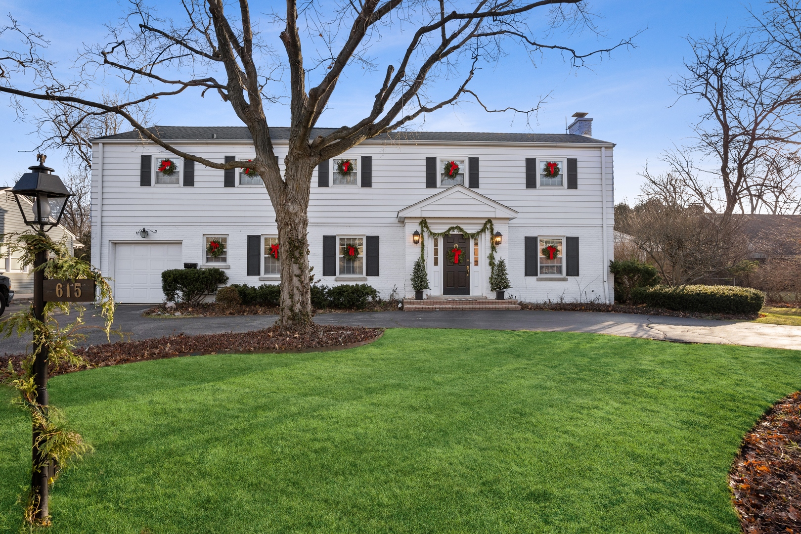 a view of white house with a yard table and chairs